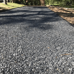 Permeable pavement driveway with gravel-filled grid system, highlighting the benefits of permeable pavement.