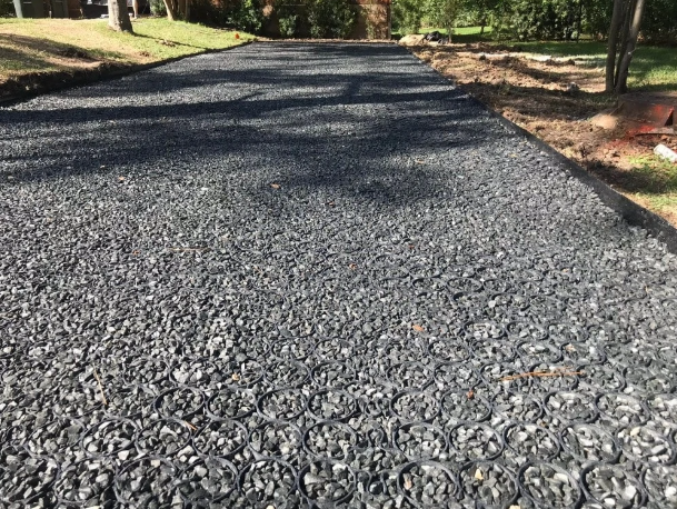 Permeable pavement driveway with gravel-filled grid system, highlighting the benefits of permeable pavement.