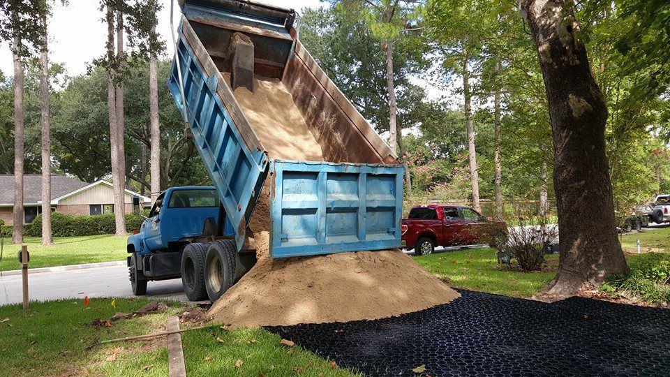 permeable pavement installation, permeable plastic grid installation, pervious pavement installation, pervious plastic grid installation, gravel dumped on permeable pavement, gravel dumped on truegrid permeable pavement,