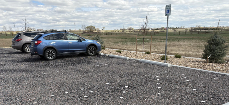 Parking lot with permeable plastic pavers allowing water drainage.