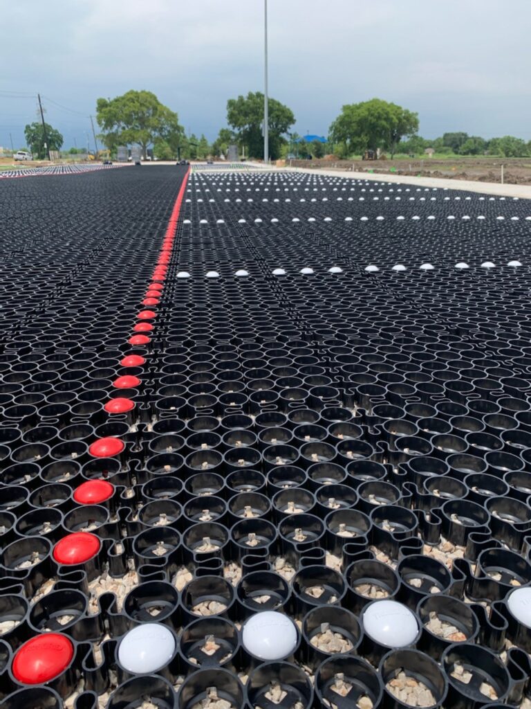 TRUEGRID Paving being used to create a parking ratio for an industrial building.