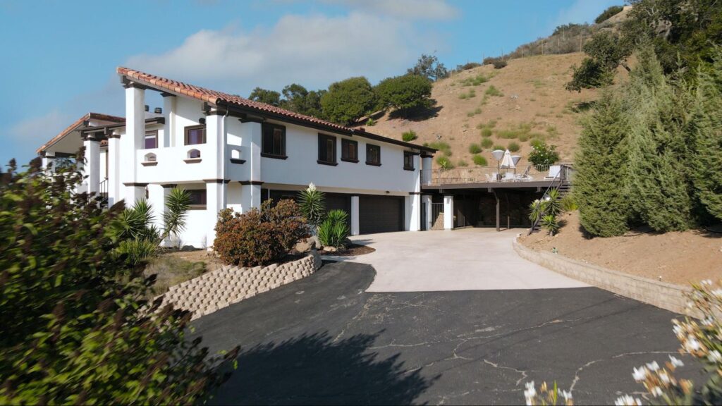 a driveway made of cement and blacktop. 