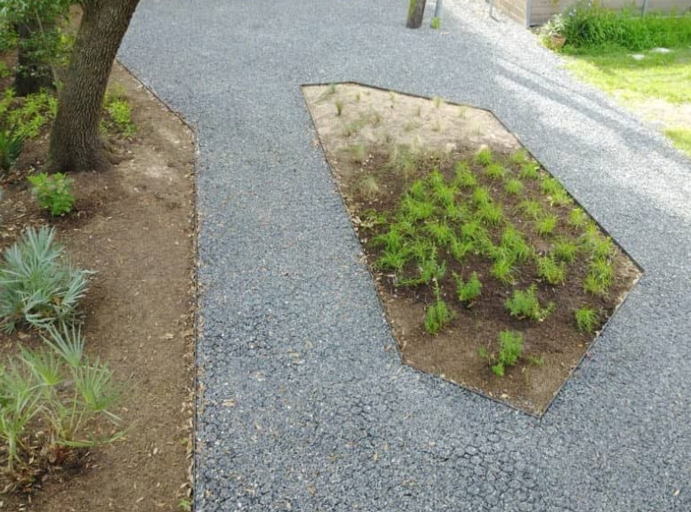 An image of garden path pavers outside of a house. 