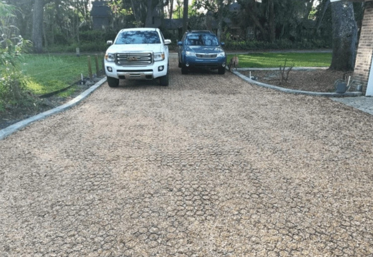 A gravel driveway system with parked cars.