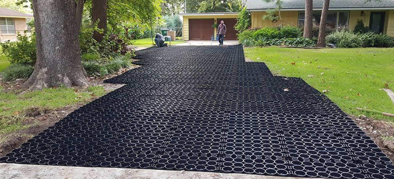 An image of a driveway with permeable paver installation in process. 