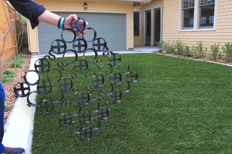 A hand-held TRUEGRID panel reveals the system’s underlying support.
