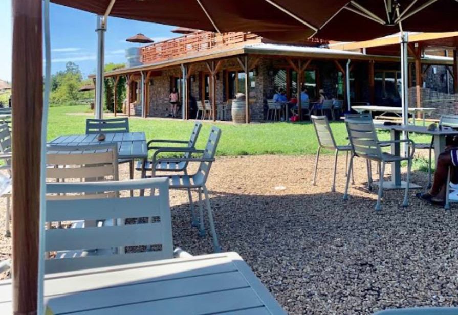 Permeable grid paver patio with proper drainage showing umbrellas and tables