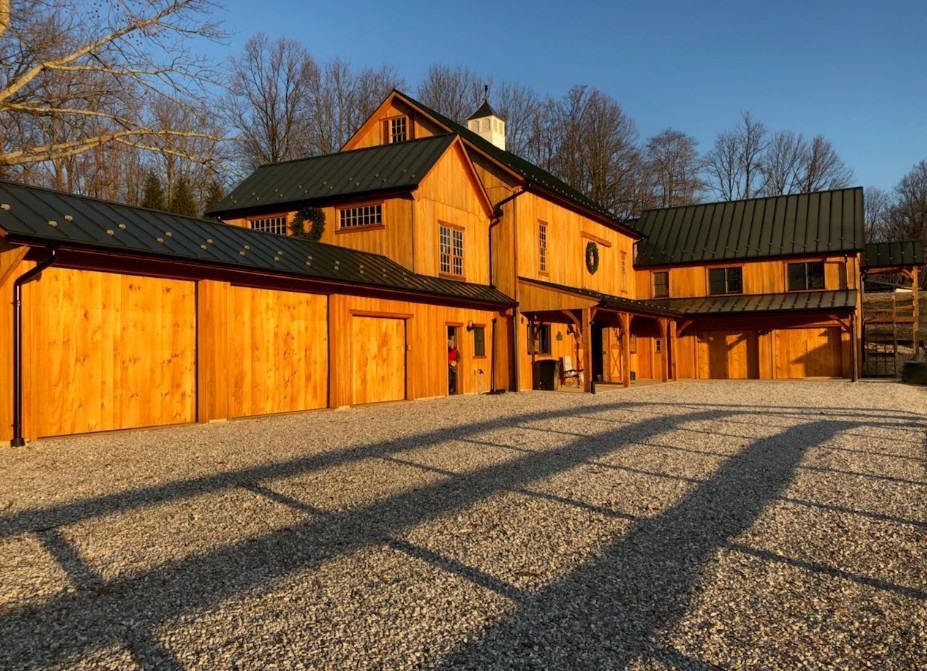Gravel driveway leading to a modern rustic house