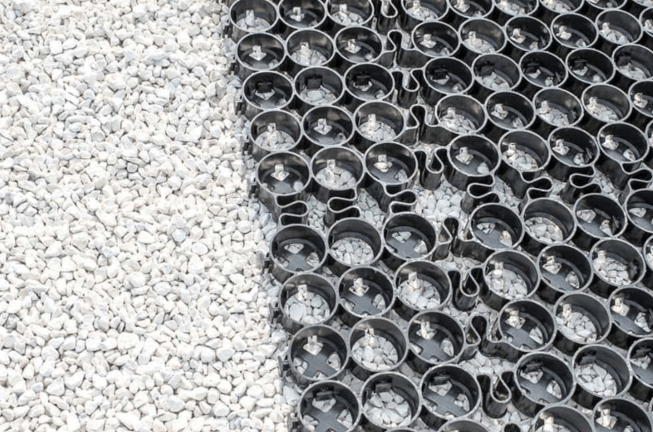 Close-up of a gravel base and unfilled gravel grid for stabilization