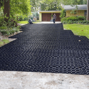 Driveway installation using black permeable plastic pavers for drainage.