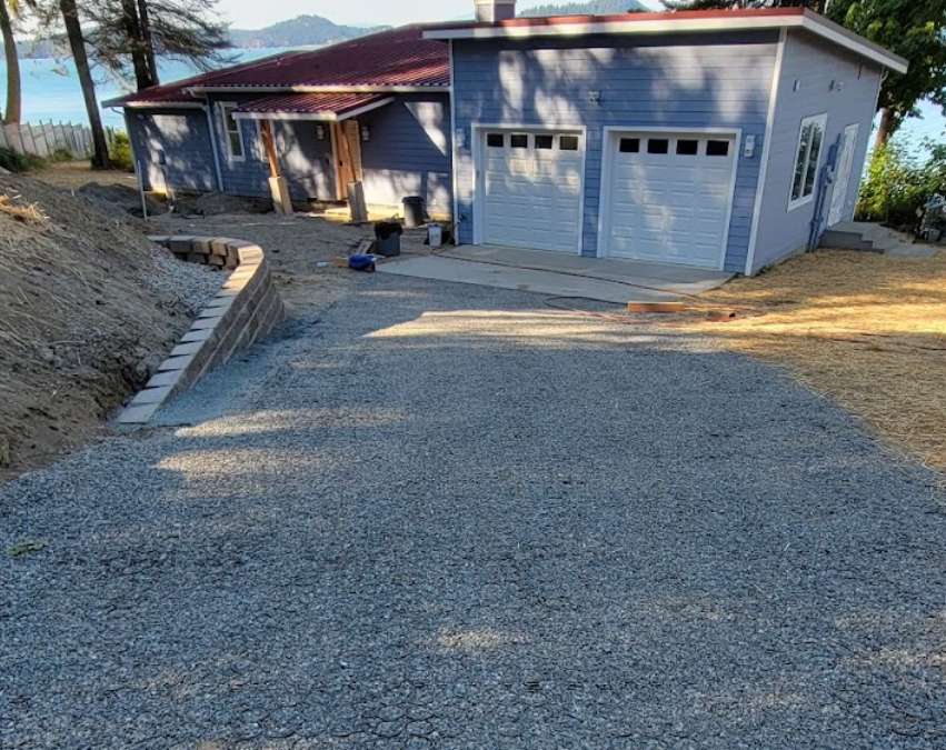 Permeable driveway grid system with filled with stone for surfacing and water drainage.