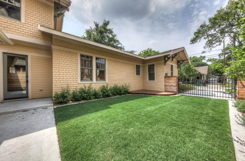 Residential yard with reinforced turf surface used as a less expensive alternative to gravel driveways.