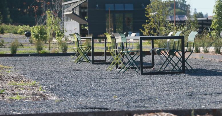 A modern gravel patio with a table and chairs