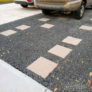 Gravel between pavers creating a stable driveway with a car.