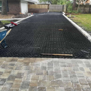 Permeable pavement grid system installed on a residential driveway highlighting the benefits of permeable pavement for drainage and stability.