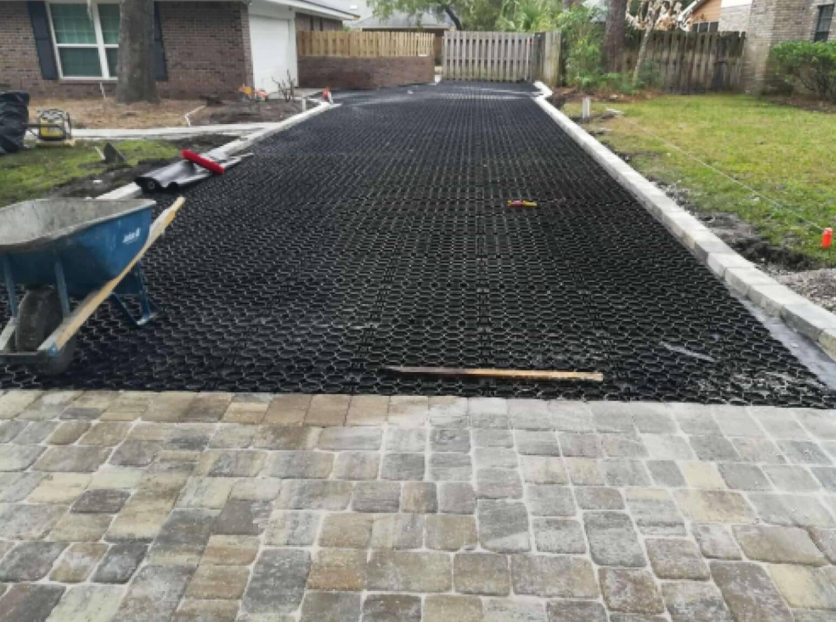 Permeable pavement grid system installed on a residential driveway highlighting the benefits of permeable pavement for drainage and stability.