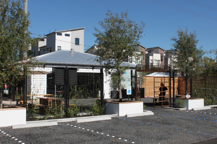 Urban parking area using permeable pavers for drainage and erosion control.