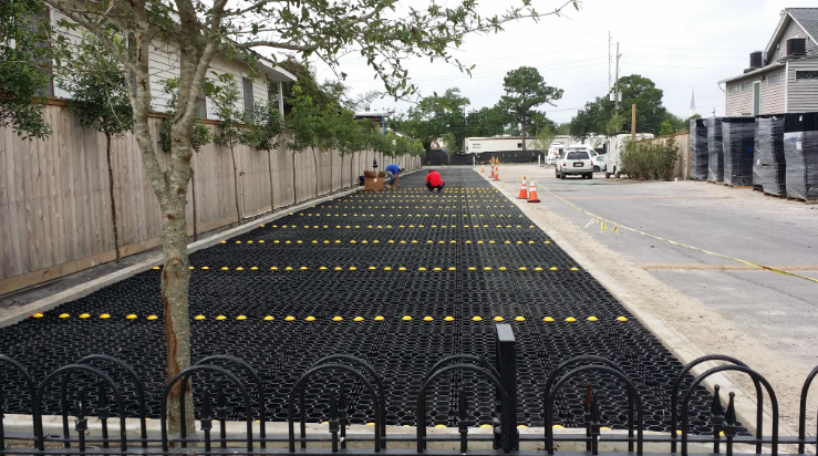 Installation of low cost permeable pavers for a parking lot surface.
