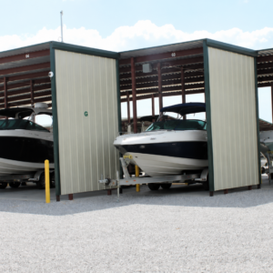 Covered boat storage facility with boats parked in individual open-sided storage bays.