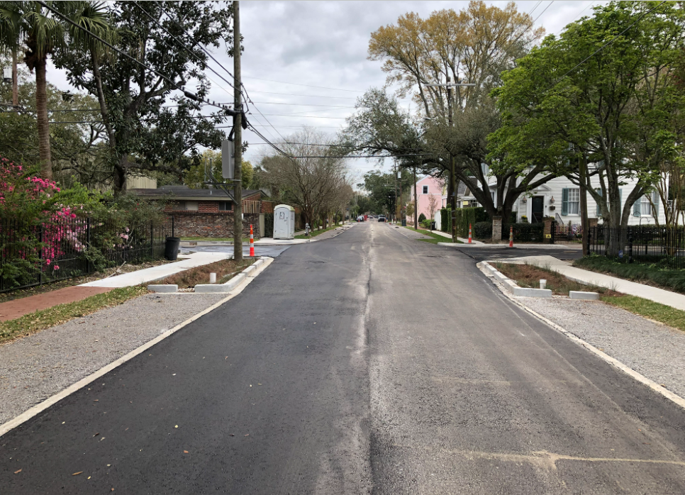 Permeable paver parking spaces next to an asphalt residential road.