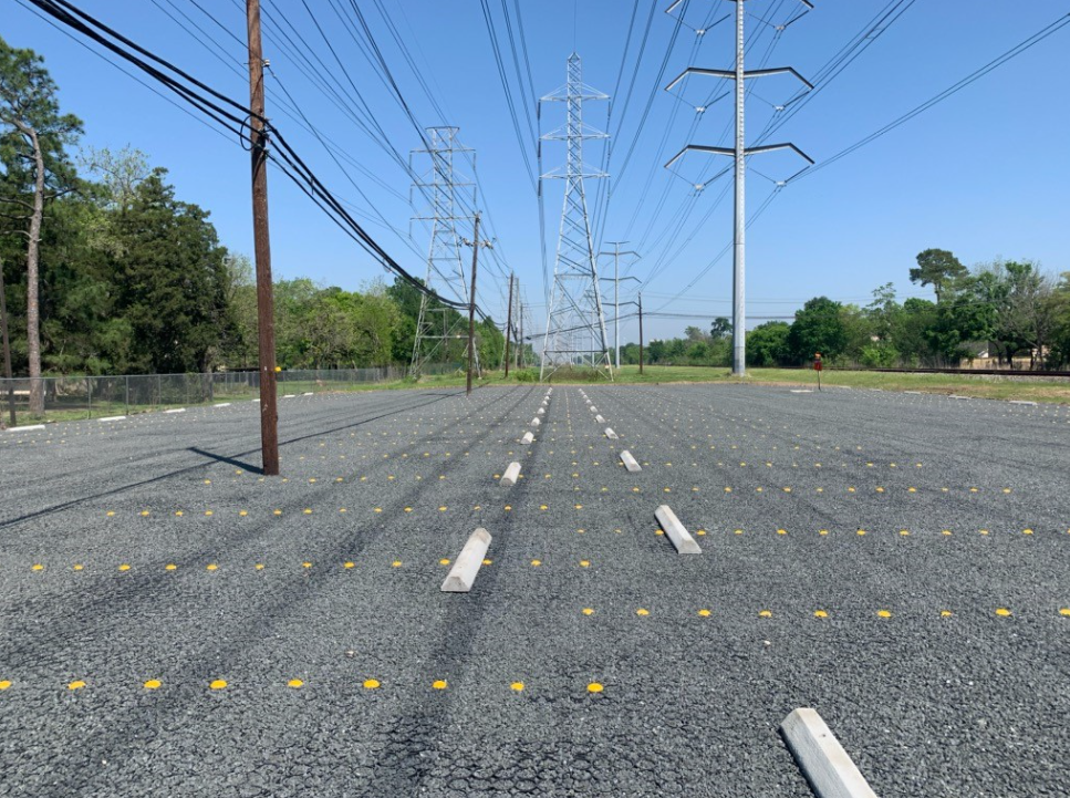 Permeable pavement system installed in an urban parking lot to support stormwater management,sustainability, and to provide utility easement.